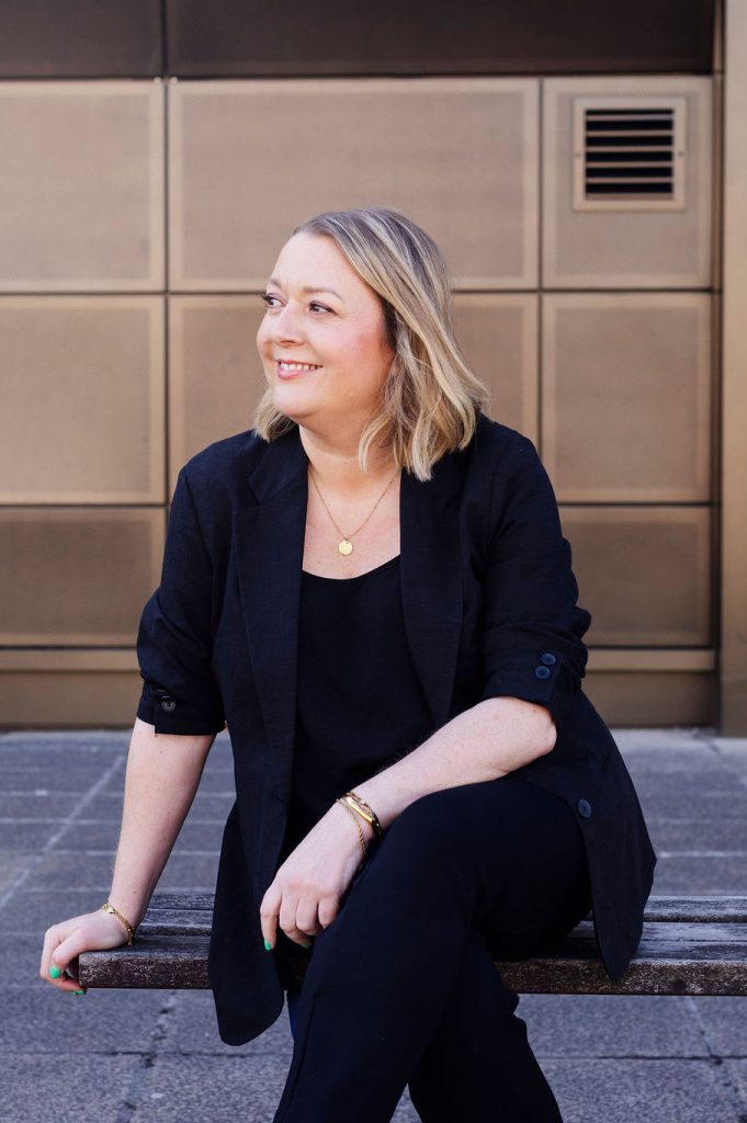 The Resilient Hairdresser sat down on a bench looking to the side